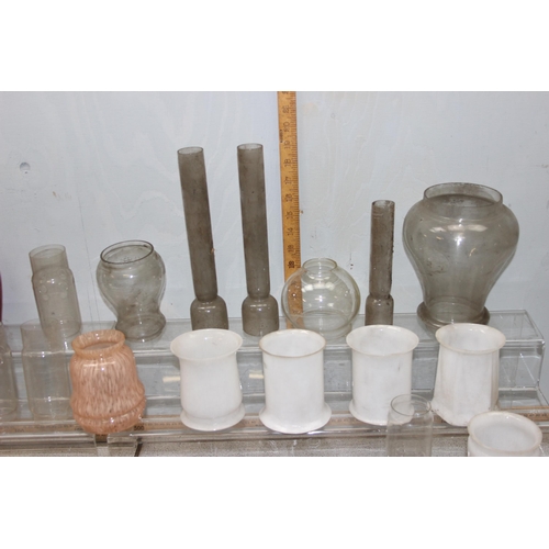 251 - A large qty of vintage oil lamp and other glass shades, chimneys and hangers