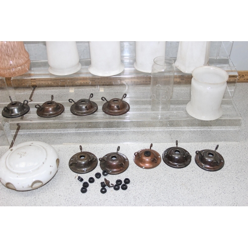 251 - A large qty of vintage oil lamp and other glass shades, chimneys and hangers