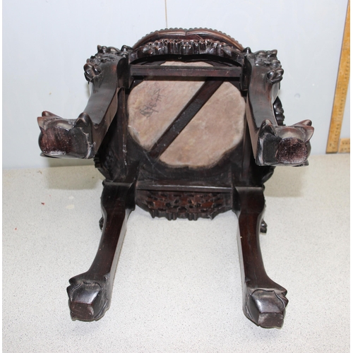 106 - A Chinese carved hardwood jardinière stand with red marble inset top, the legs profusely carved with... 