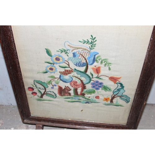 112 - A small folding table and a vintage embroidered fire screen