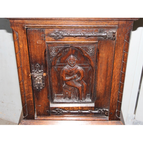 118 - A 17tn century style oak cupboard on stand with carved details and wrought iron hinges, approx 115cm... 