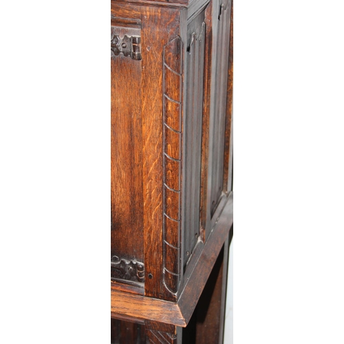 118 - A 17tn century style oak cupboard on stand with carved details and wrought iron hinges, approx 115cm... 