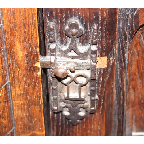 118 - A 17tn century style oak cupboard on stand with carved details and wrought iron hinges, approx 115cm... 