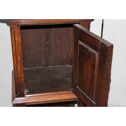 118 - A 17tn century style oak cupboard on stand with carved details and wrought iron hinges, approx 115cm... 