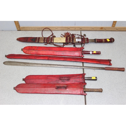 1410 - 5 assorted ethnic swords in leather sheaths, likely African, one with straw-work decoration