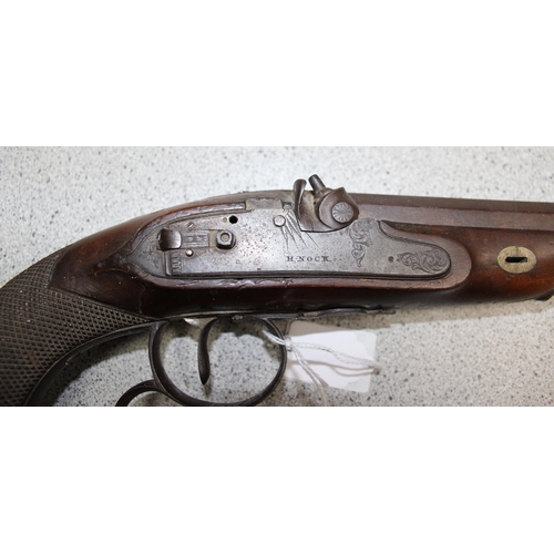 1412 - H. Nock 19th century percussion cap pistol with wooden handle and a leather shot flask