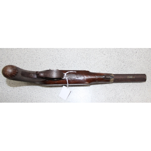 1412 - H. Nock 19th century percussion cap pistol with wooden handle and a leather shot flask