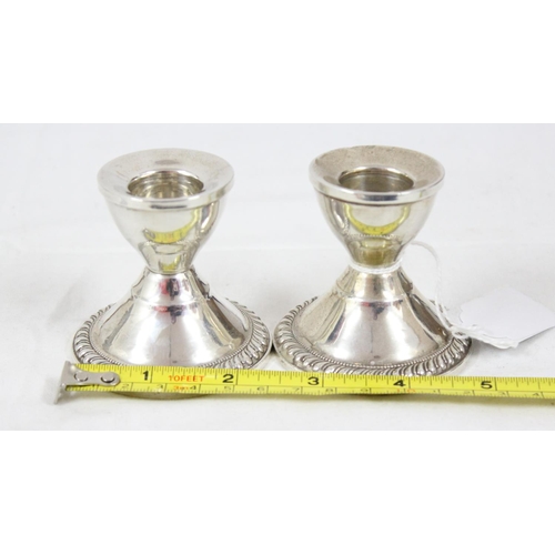 1042 - A pair of sterling silver dwarf candlesticks, weighted, likely American, approx 6cm tall