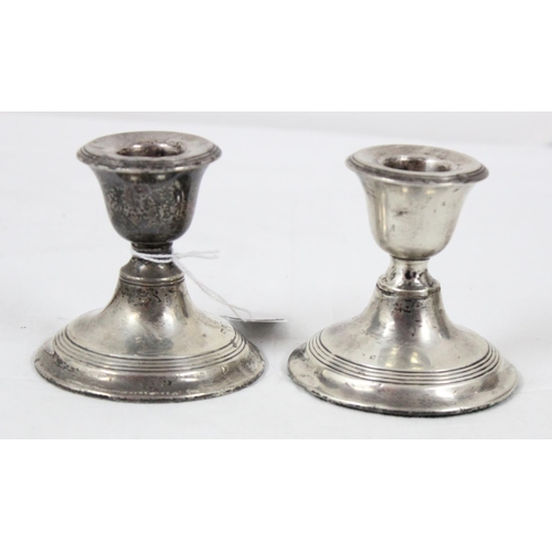 1043 - A pair of sterling silver dwarf candlesticks, weighted, English but hallmarks rubbed, likely Birming... 