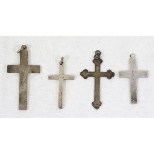 1106 - 4 assorted silver crucifix pendants