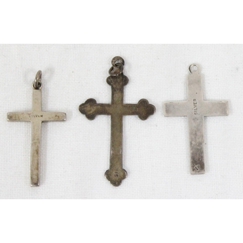 1106 - 4 assorted silver crucifix pendants