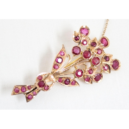 1116 - An antique 14ct gold and ruby set brooch formed as a floral spray, the largest ruby approx 5mm in di... 