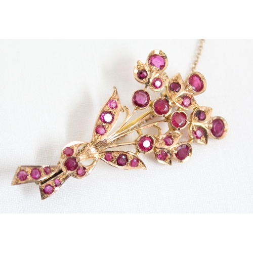 1116 - An antique 14ct gold and ruby set brooch formed as a floral spray, the largest ruby approx 5mm in di... 