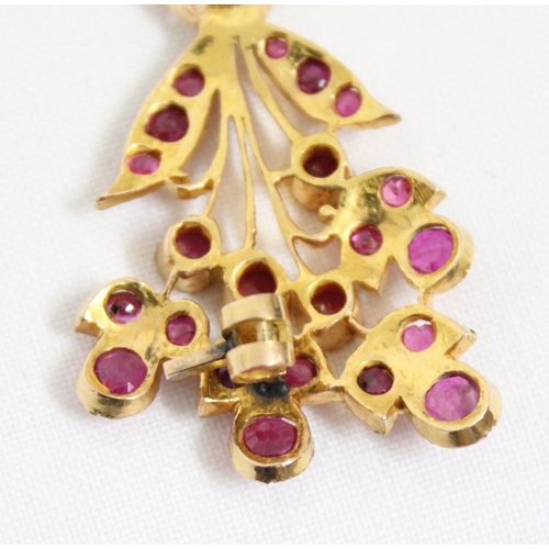 1116 - An antique 14ct gold and ruby set brooch formed as a floral spray, the largest ruby approx 5mm in di... 