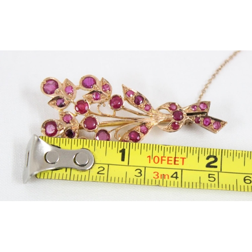 1116 - An antique 14ct gold and ruby set brooch formed as a floral spray, the largest ruby approx 5mm in di... 