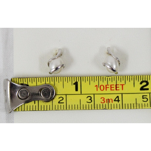 1122 - A pair of 9ct white gold and pearl earrings in original box