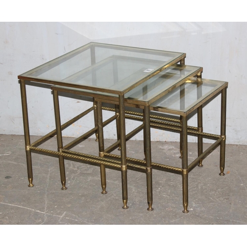 85 - A vintage nest of 3 brass tables with glass tops and twisted column supports