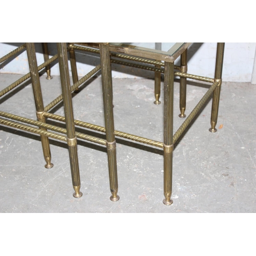 85 - A vintage nest of 3 brass tables with glass tops and twisted column supports