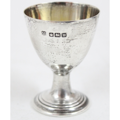 1054 - A small silver toast rack, London 1933, a silver egg cup Sheffield 1914 & a small silver plated toas... 