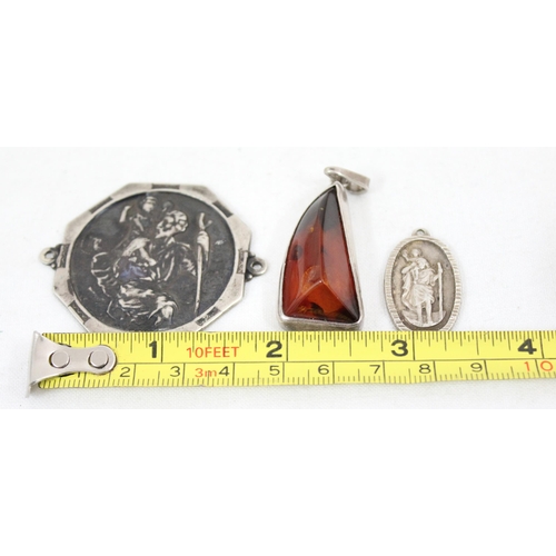 1150 - 3 silver pendants, 2 St Christopher & silver mounted amber