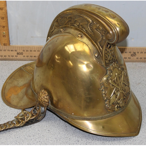 1442 - An antique brass fireman's helmet, believed to be Merryweather patent with embossed brass dragons an... 