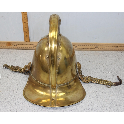 1442 - An antique brass fireman's helmet, believed to be Merryweather patent with embossed brass dragons an... 