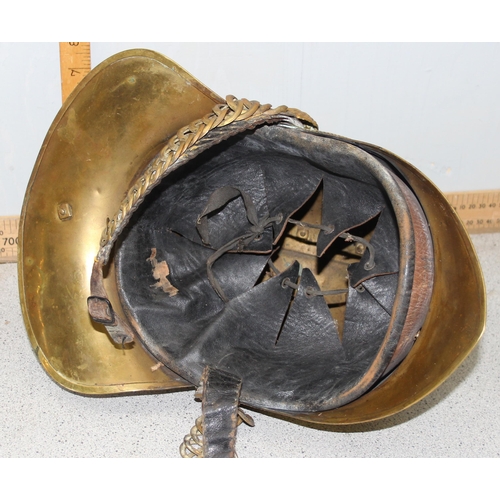 1442 - An antique brass fireman's helmet, believed to be Merryweather patent with embossed brass dragons an... 