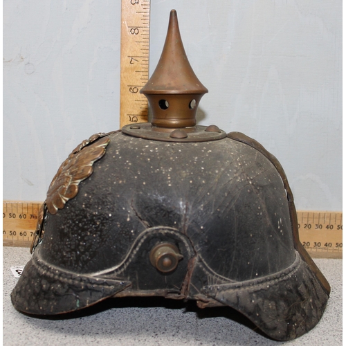 1443 - An original WW1 period German Pickelhaube helmet on leather and brass construction with liner and ea... 