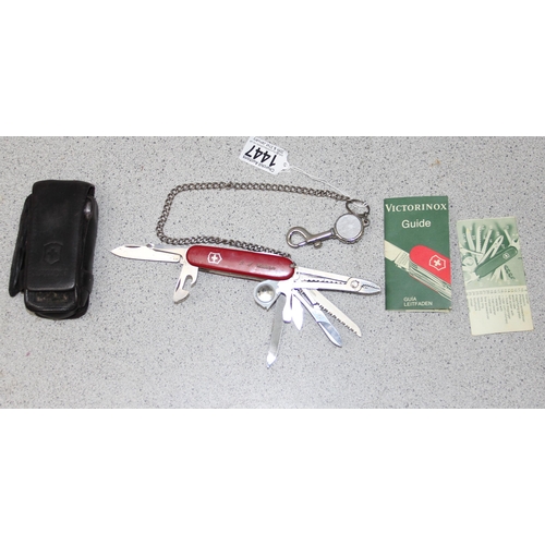 1447 - A large Victorinox penknife with leather case and manual with 11 attachments