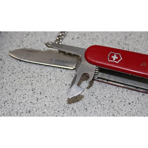 1447 - A large Victorinox penknife with leather case and manual with 11 attachments