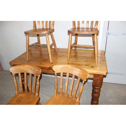 128 - A large pine farmhouse dining table and 4 farmhouse kitchen chairs, the table approx 153cm x 77cm