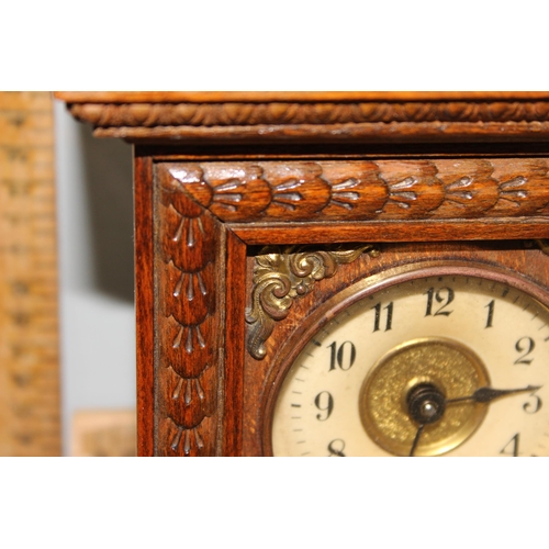 1353 - An early 20th century oak cased mantel clock with key