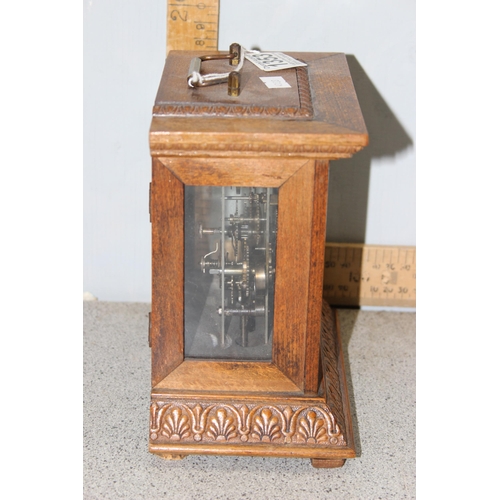 1353 - An early 20th century oak cased mantel clock with key