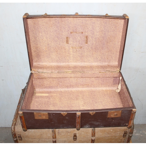 139 - 4 early 20th century canvas and wooden shipping trunks, some with writing