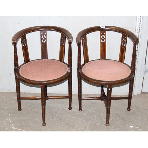 152 - A pair of early 20th century horse shoe shaped backed bedroom chairs with pink upholstered seats