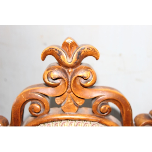 153 - An antique low fruitwood chair with floral upholstered seat