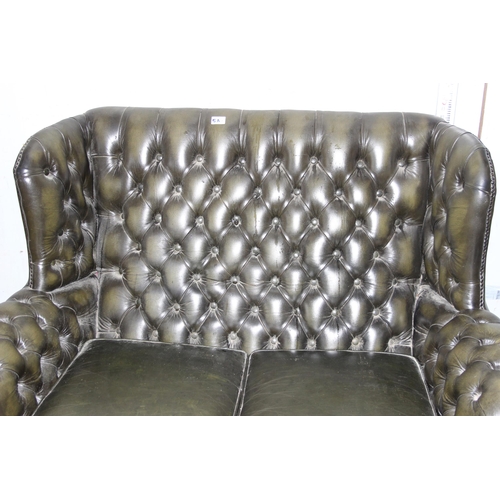 5A - A green Chesterfield high backed 2 seater sofa with matching button footstool