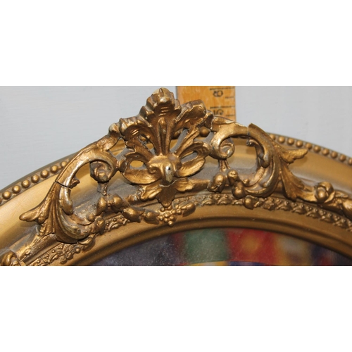 460 - A pair of vintage oval gilt framed wall mirrors with rococo style details, approx 57cm tall