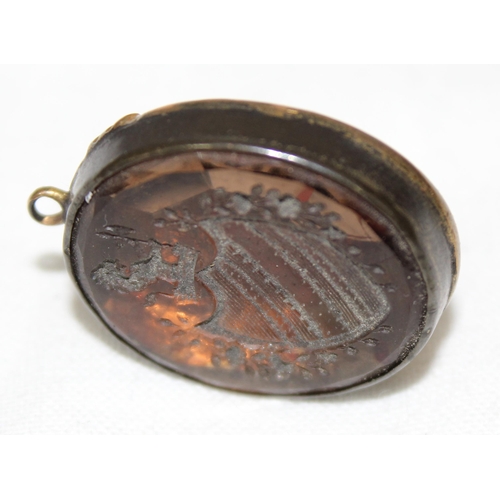 1137 - A mounted intaglio fob seal of a heraldic shield, approx 30mm tall, with gold plated back