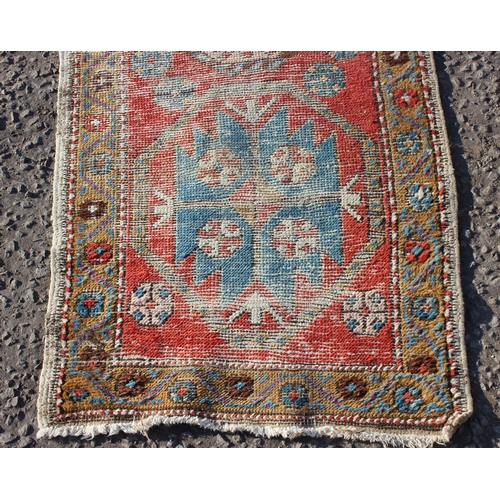 202 - A vintage worn hall runner rug, approx 270cm x 68cm