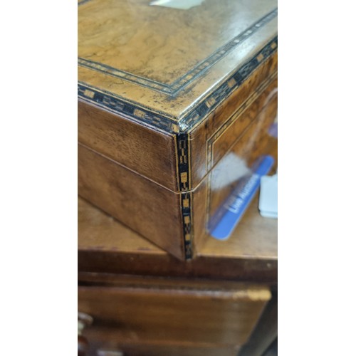 276 - An antique walnut inlaid sewing box with fitted interior