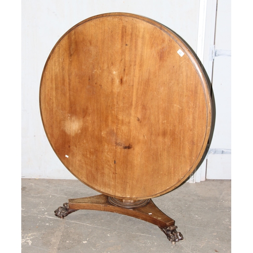 65 - A 19th century mahogany tilt topped breakfast table with pedestal base and carved lion paw feet, app... 