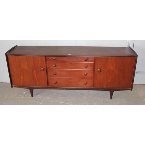 10A - A mid-century dark sideboard by A. Younger Limited, comprising of a central bank of 4 drawers flanke... 