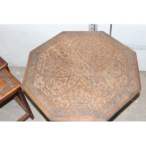 15 - A vintage carved Indian hardwood nest of tables and a similar carved wooden octagonal table