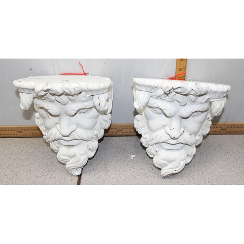 284 - A pair of white painted plaster wall brackets formed as the head of a classical god, approx 25cm tal... 