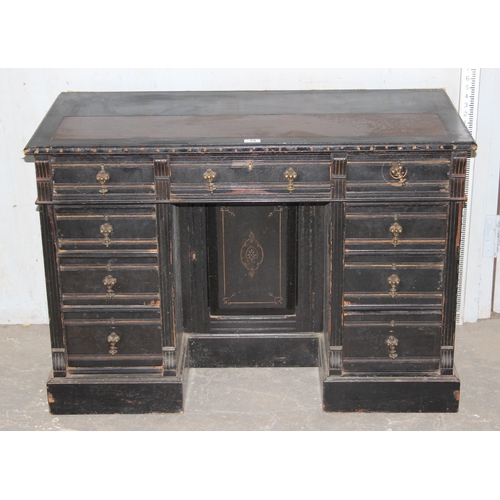 34 - A Victorian ebonised pedestal desk with 9 drawers and brass drop handles, approx 108cm wide