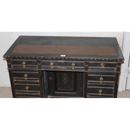 34 - A Victorian ebonised pedestal desk with 9 drawers and brass drop handles, approx 108cm wide