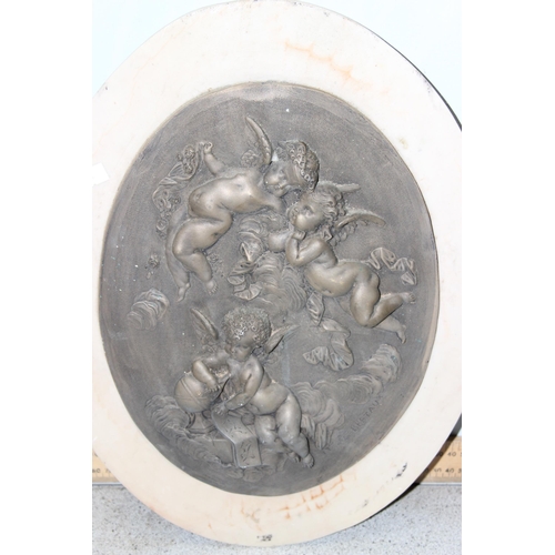 401 - After Leon Bertaux, a pair of bronzed marble effect relief plaques depicting putti/ cherubs, approx ... 