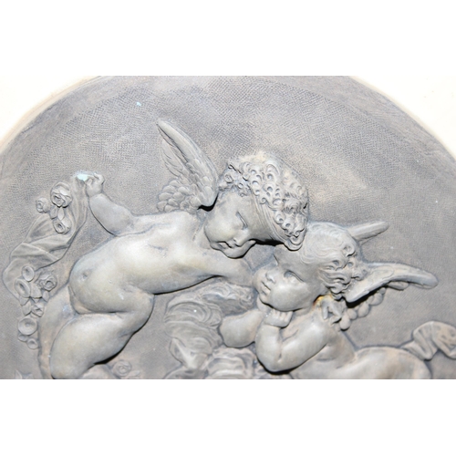 401 - After Leon Bertaux, a pair of bronzed marble effect relief plaques depicting putti/ cherubs, approx ... 