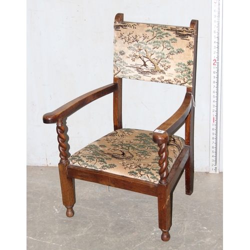 44 - An Art Deco period oak framed low armchair with barleytwist supports